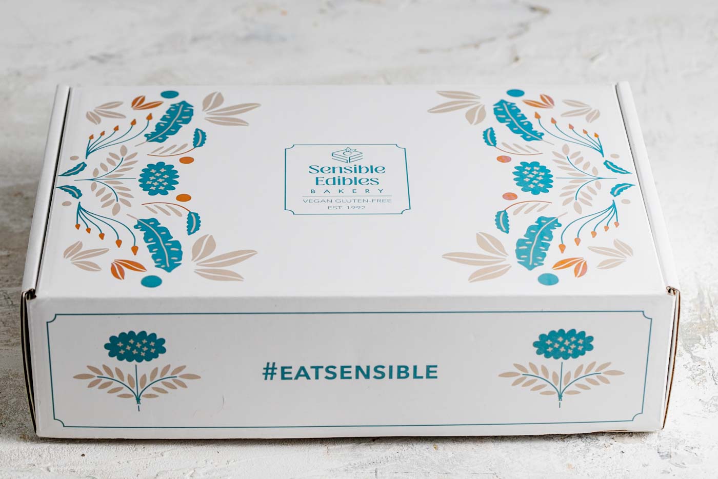 Closed gift box with floral desig and sensible edibles logo