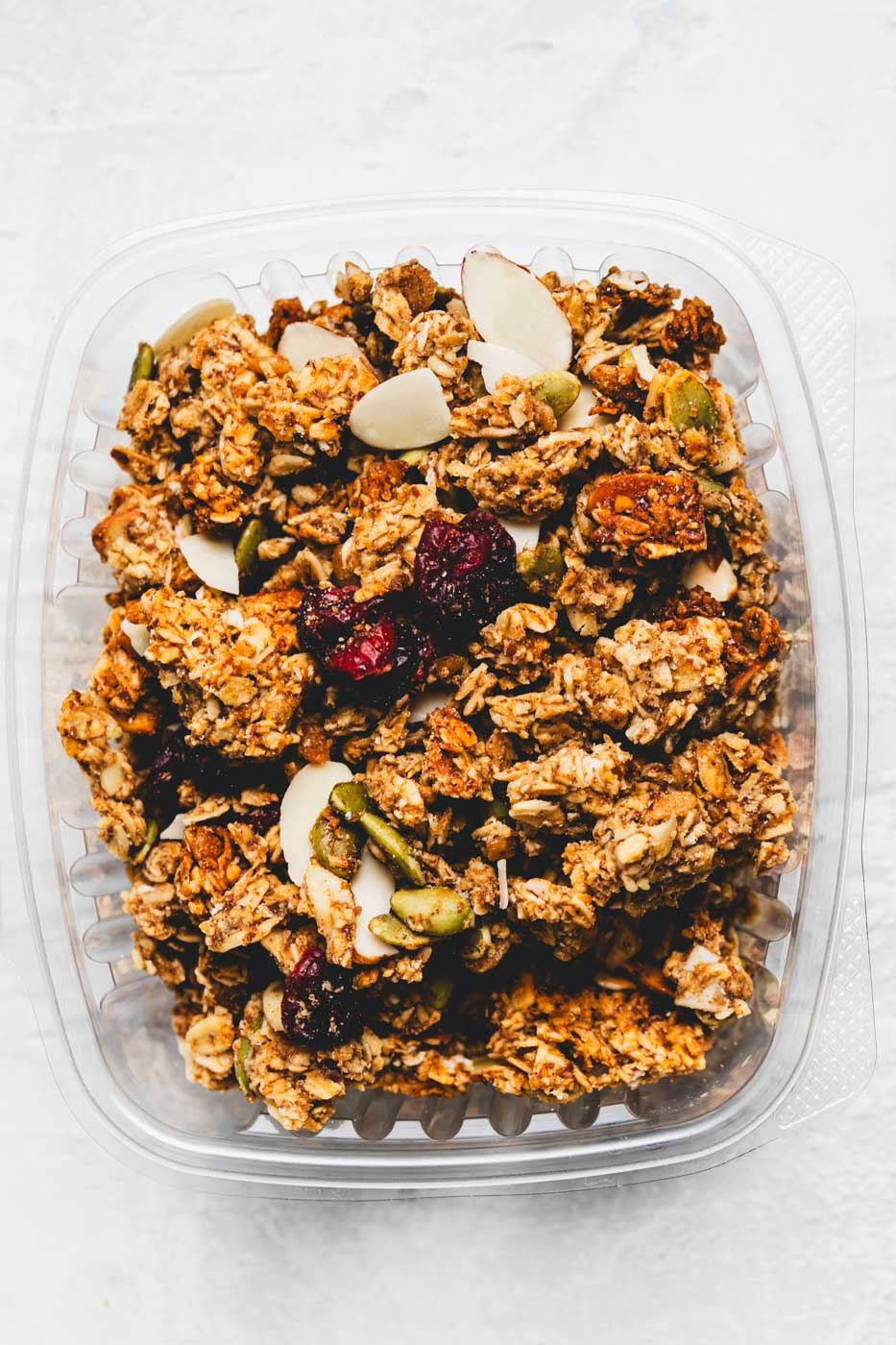 Open box of granola with oats, pumpkin seeds, almonds, and cranberries