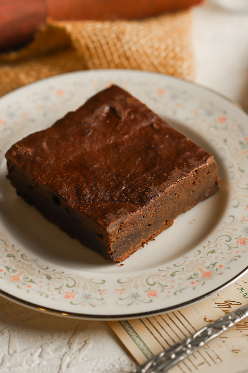 Brownie on a decorative plate with a blurred background