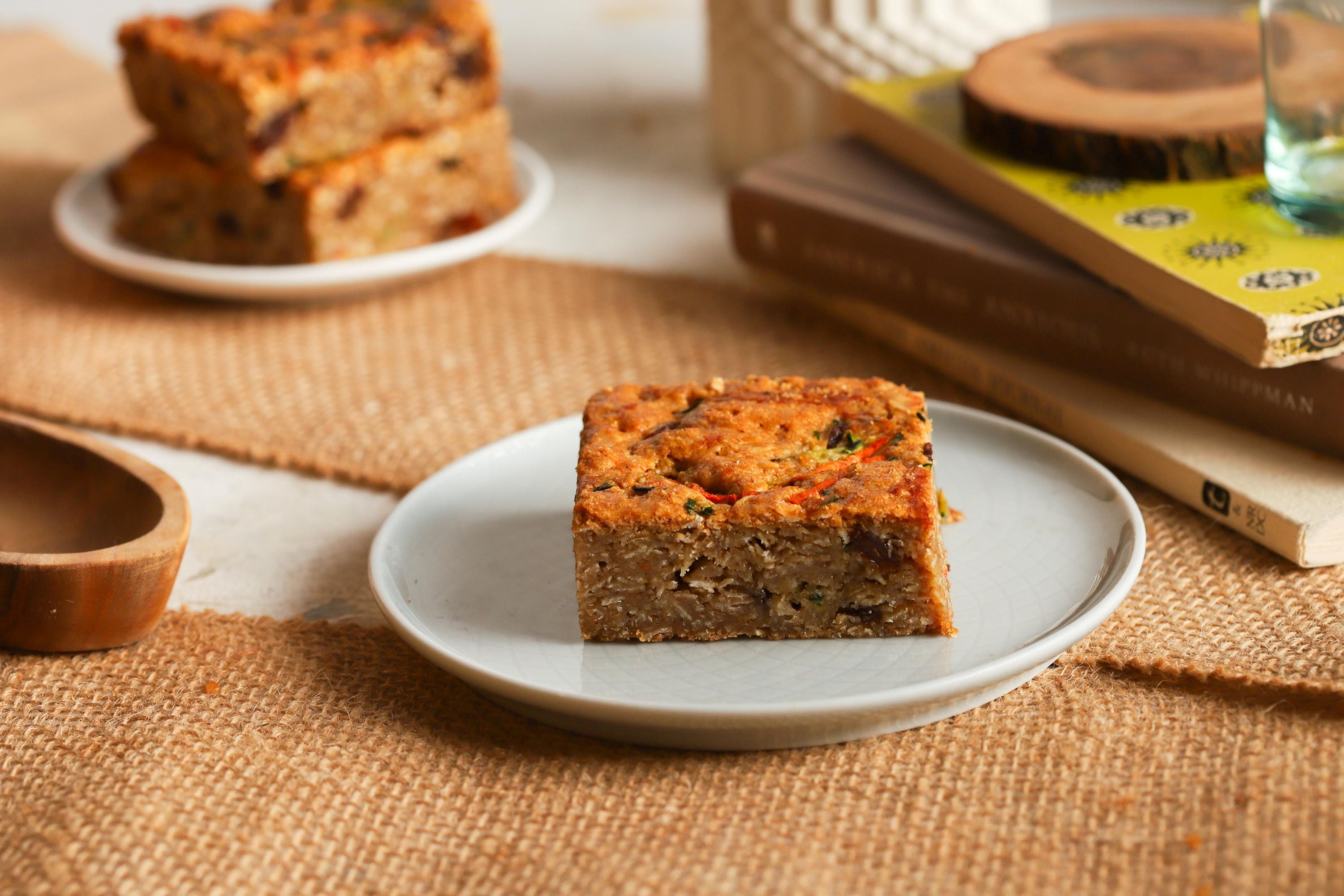 A grassroot bar on a white plate on top of burlap with more bars in the background