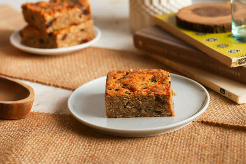 A grassroot bar on a white plate on top of burlap with more bars in the background