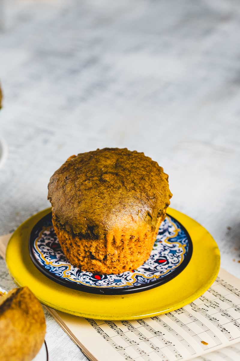 A Lemon Matcha Muffin on a blue and white patterned plate