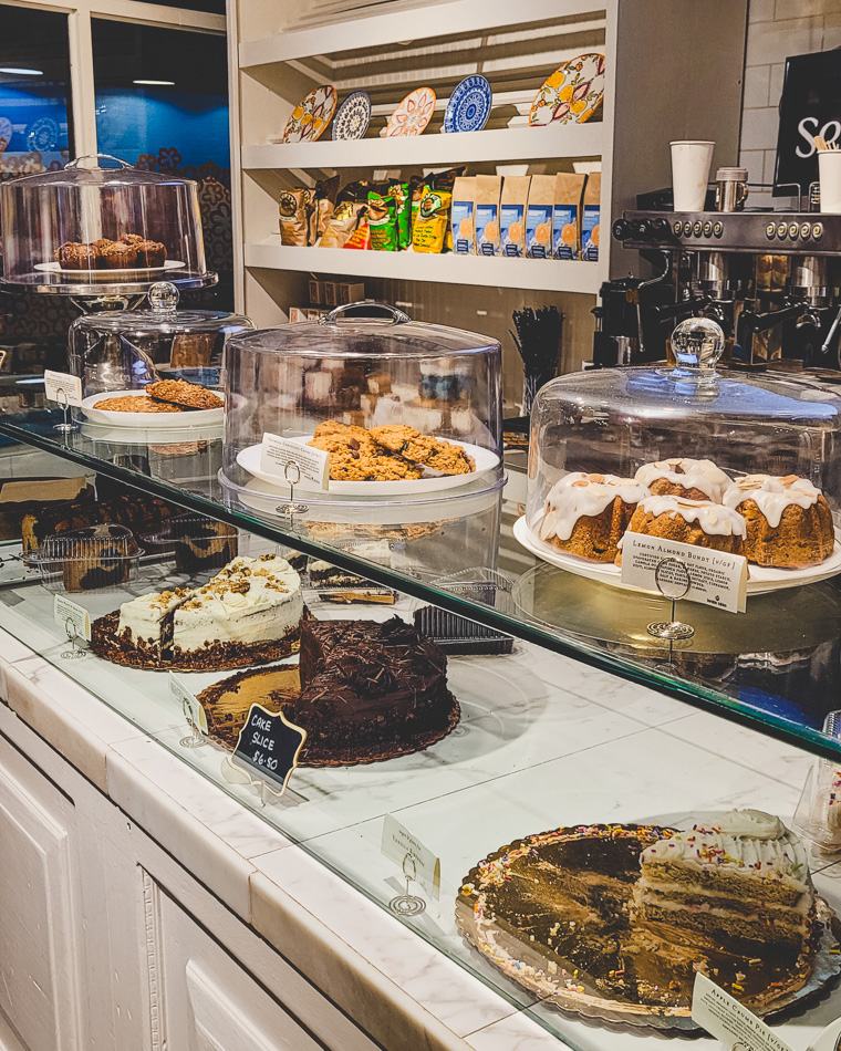 The Sensible Bakery counter in Long Island City: cake stands and domed plates along a glass case, an espresso machine behind.